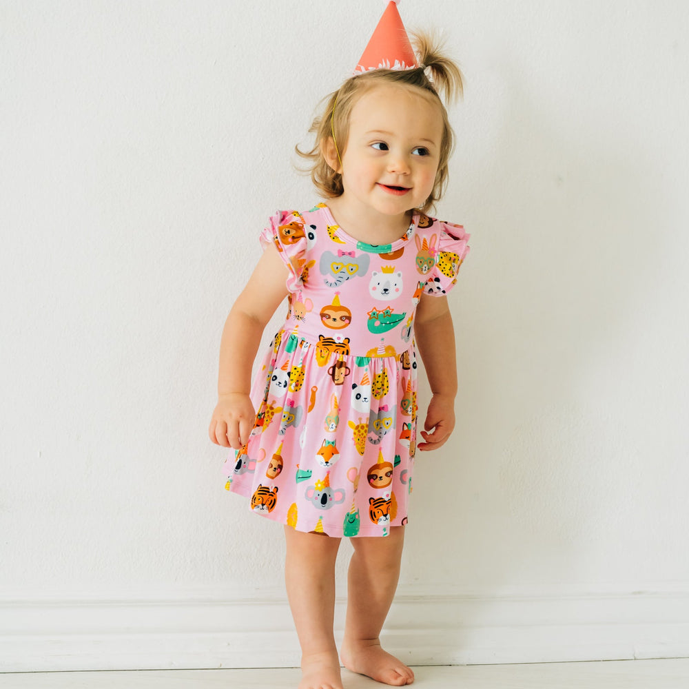 Child wearing a Pink Party Animals flutter skater dress with bodysuit