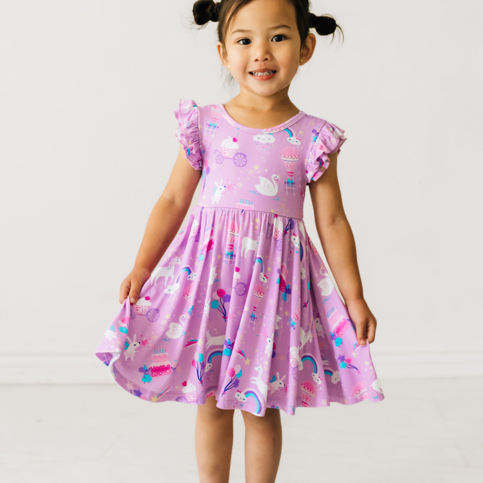 Child posing wearing a Magical Birthday Flutter twirl dress