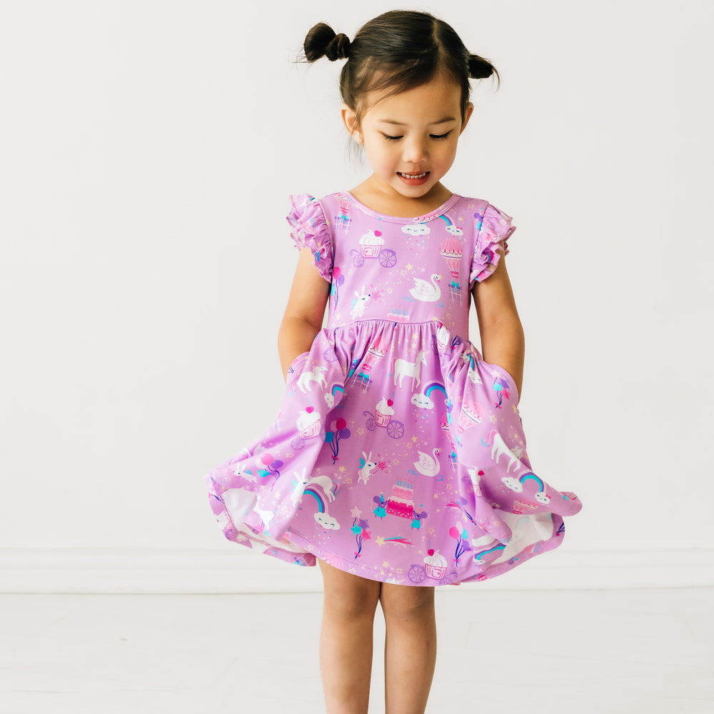 child playing wearing a Magical Birthday Flutter twirl dress