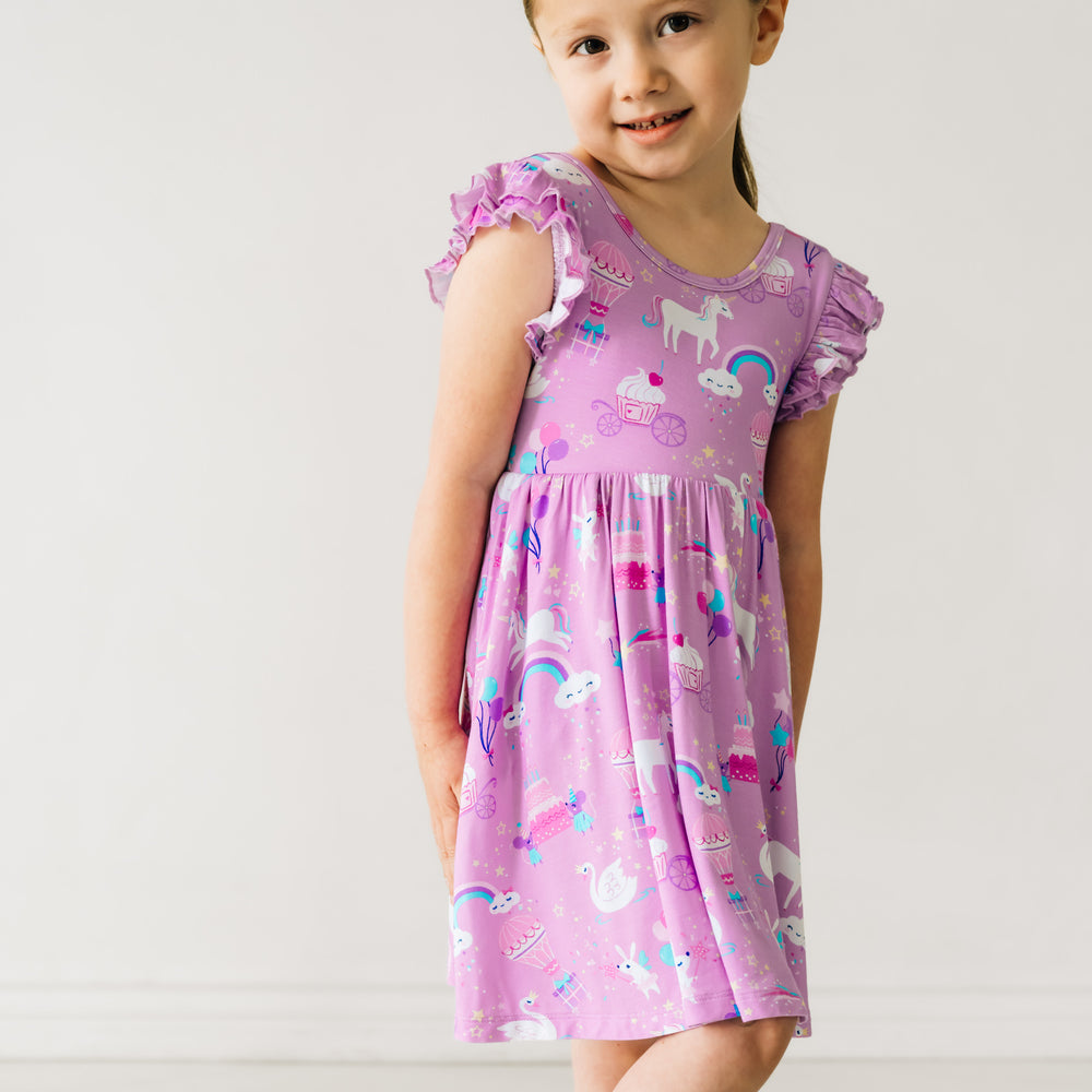 Child posing wearing a Magical Birthday Flutter Twirl Dress