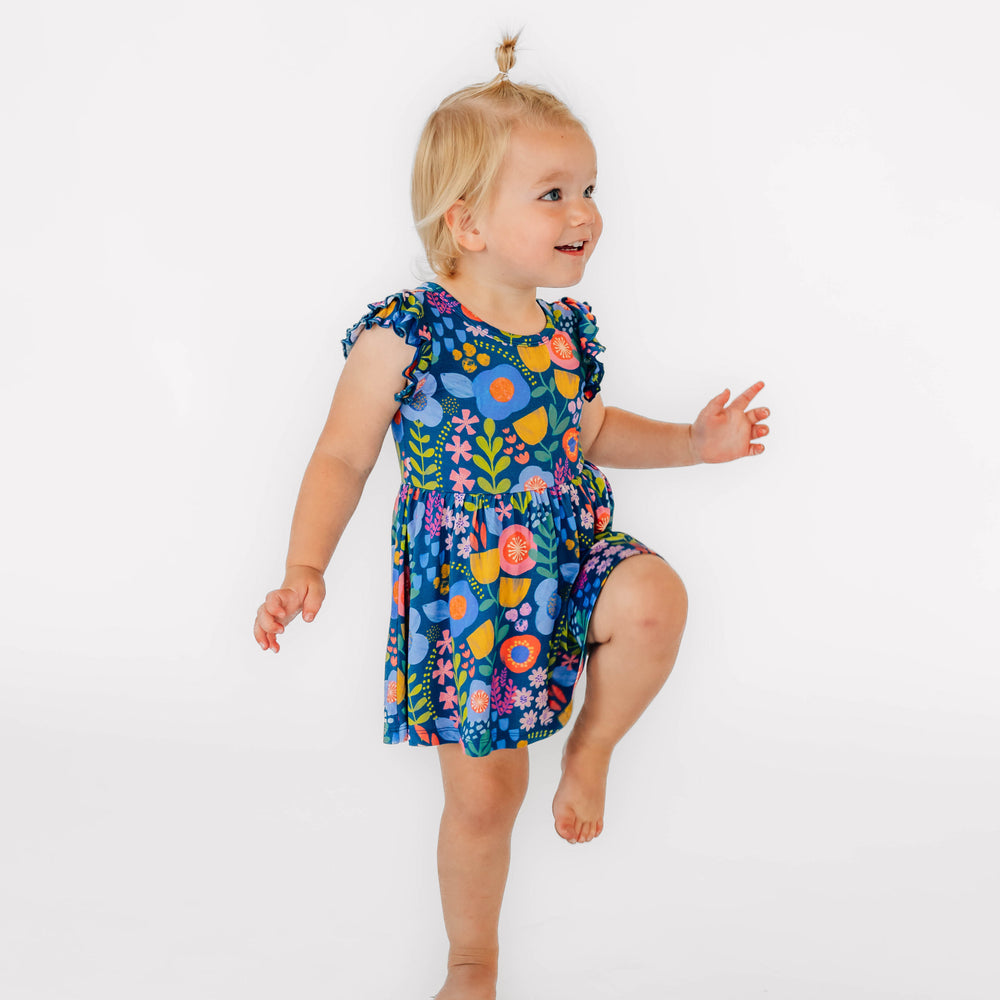 Girl posing while wearing the Folk Floral Flutter Twirl Dress with Bodysuit 