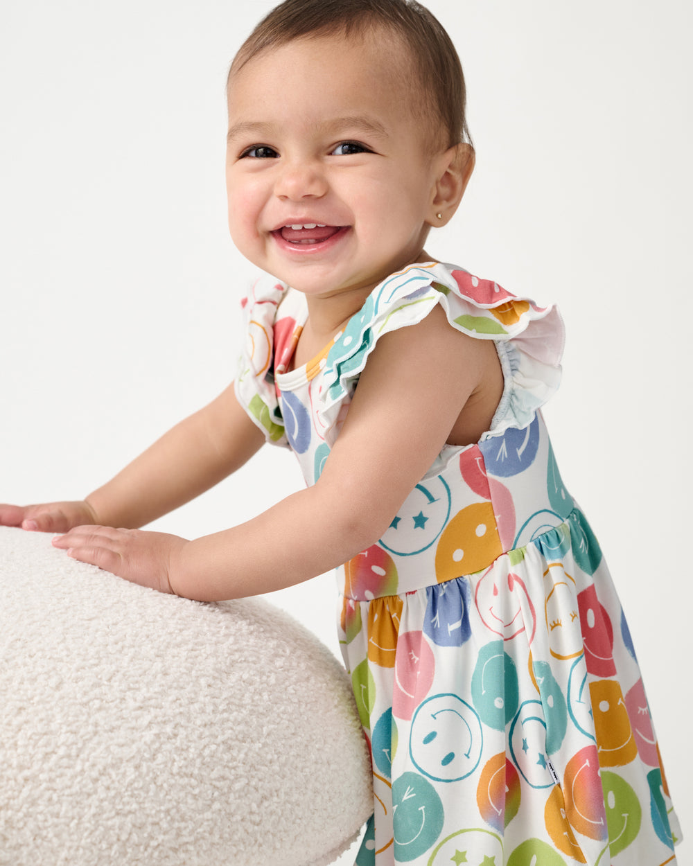 Baby wearing the Positive Vibes Flutter Twirl Dress with Bodysuit