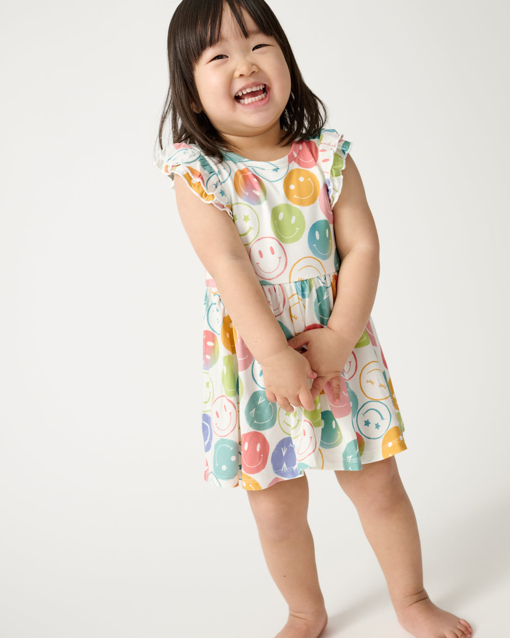 Toddler wearing the Positive Vibes Flutter Twirl Dress with Bodysuit