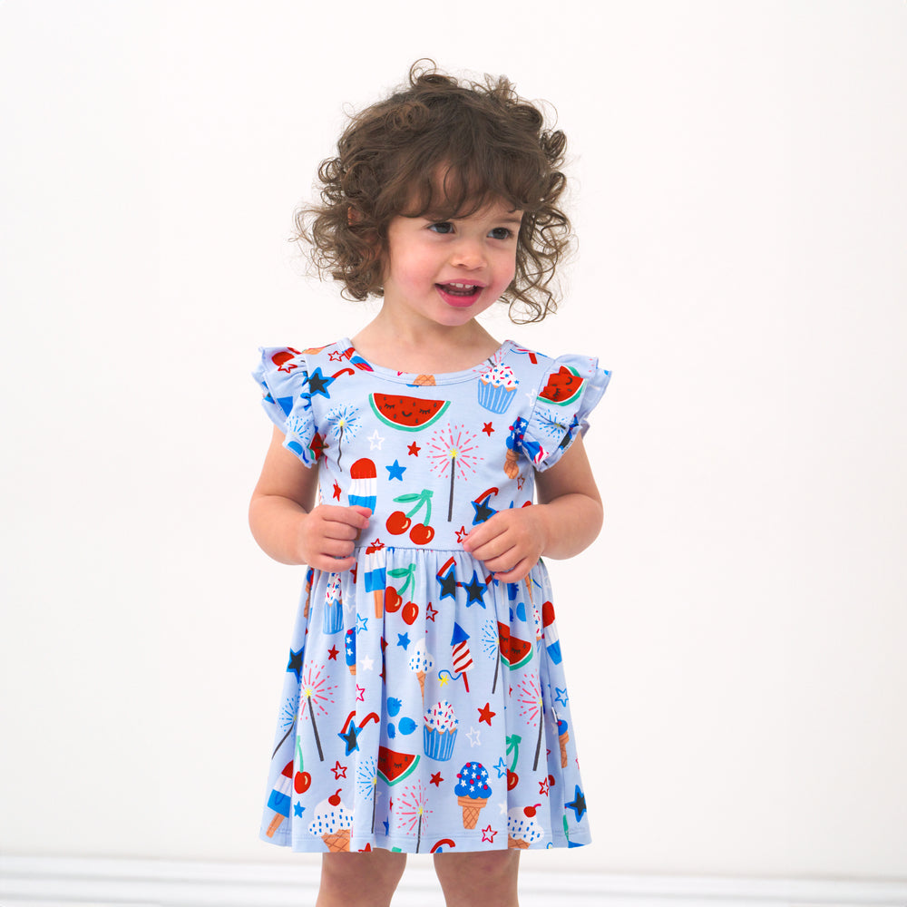 Child wearing a Stars, Stripes, and Sweets flutter twirl dress with bodysuit