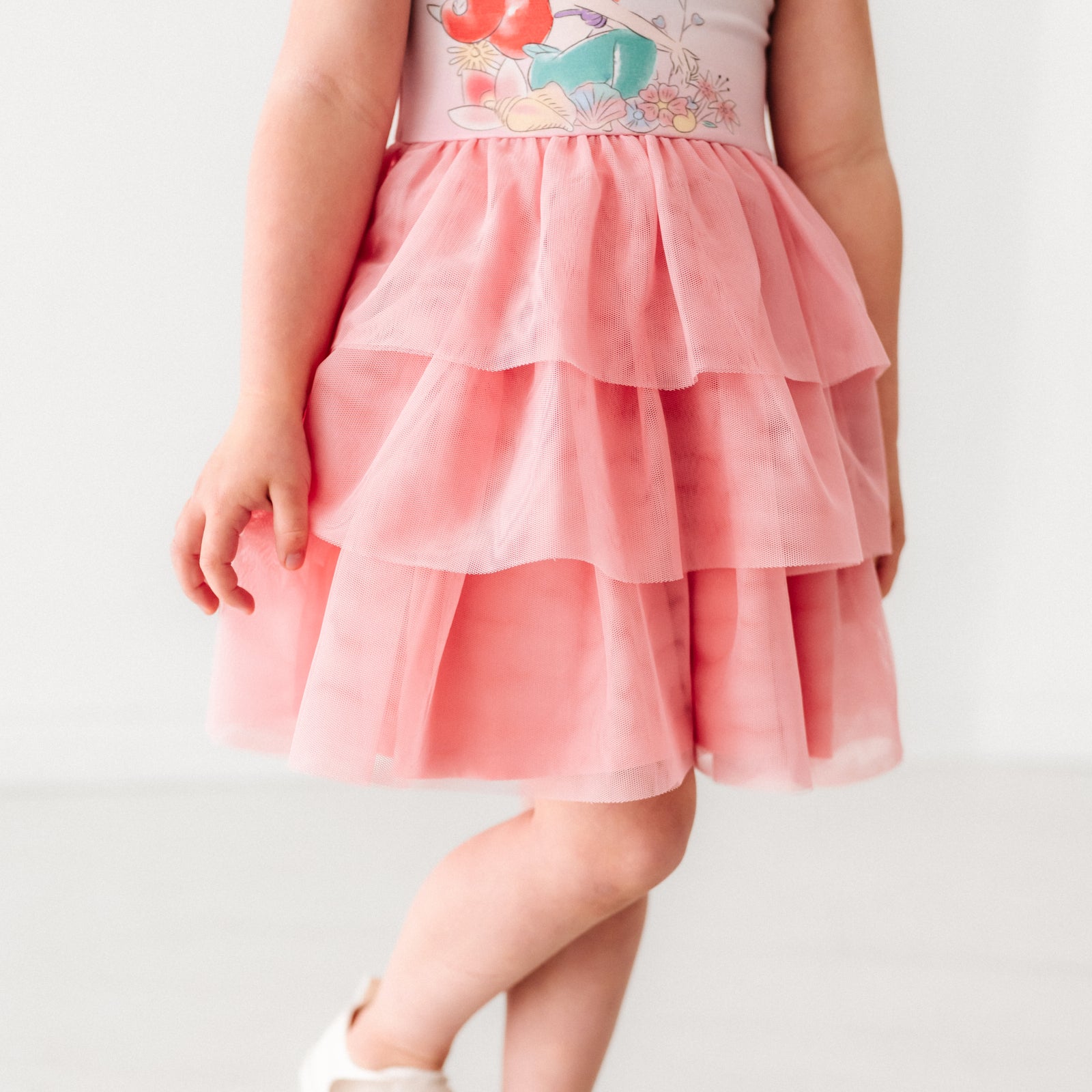 Close up image of a child wearing an Ariel flutter tiered tutu dress