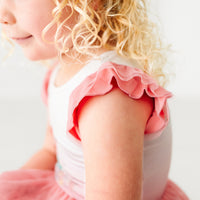 Close up image of a child wearing an Ariel flutter tiered tutu dress, detailing the flutter sleeve