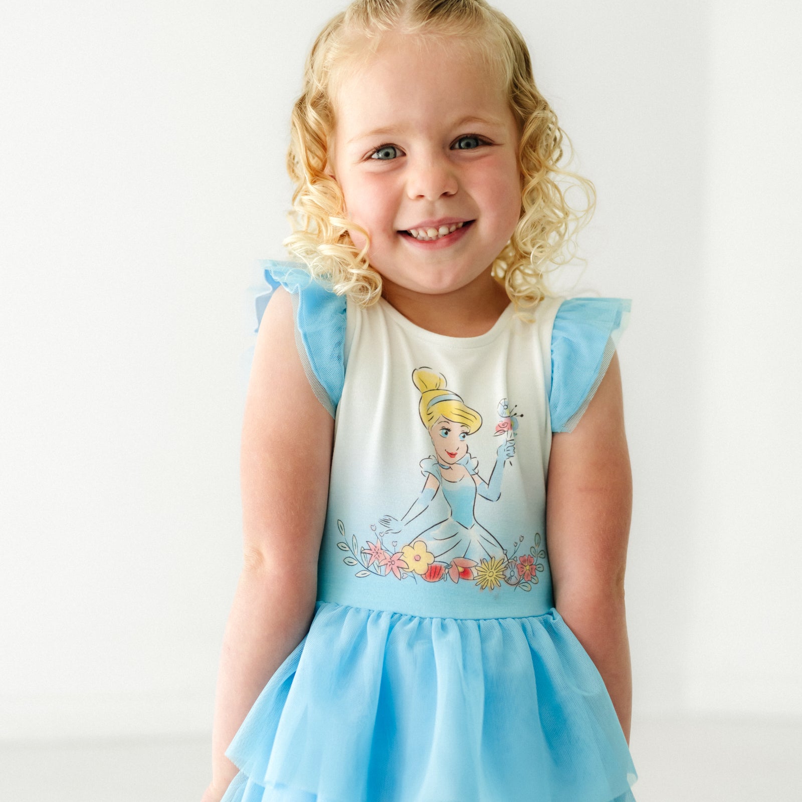 Close up image of a child wearing a Cinderella flutter tiered tutu dress