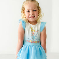 Close up image of a child wearing a Cinderella flutter tiered tutu dress