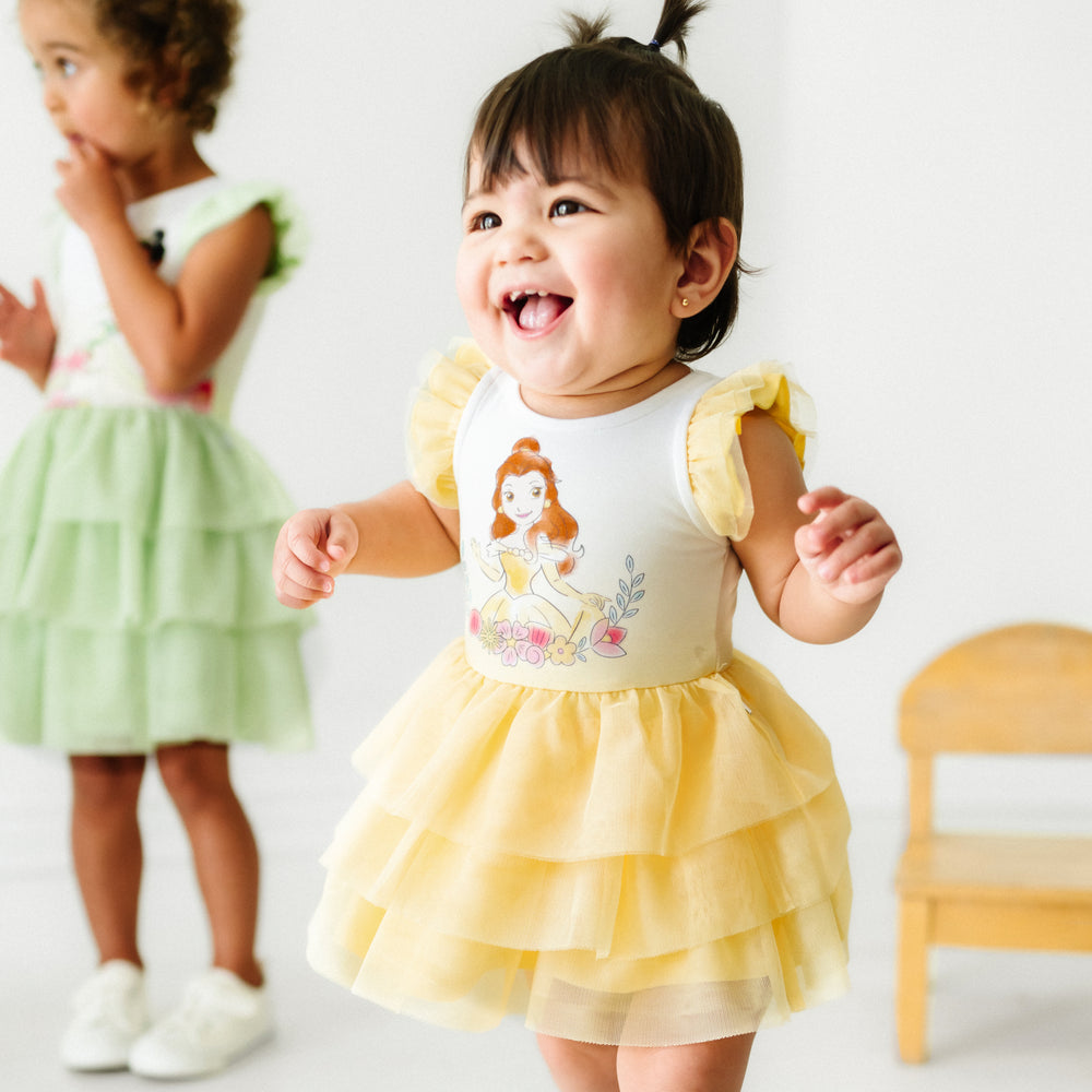 Close up image of a child wearing a Belle flutter tiered tutu dress with bloomer