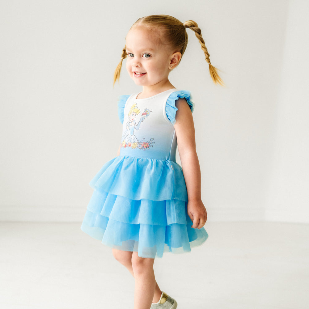 Child spinning around wearing a Cinderella flutter tiered tutu dress with bloomer