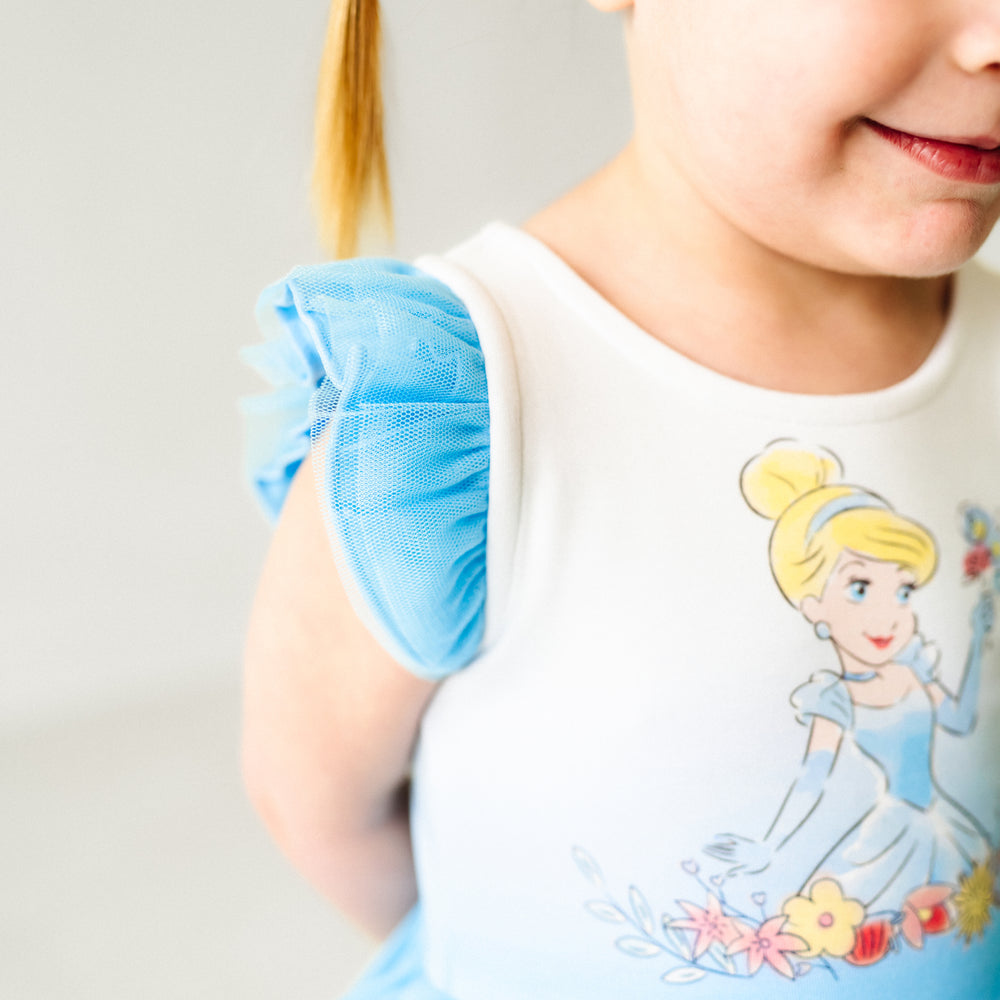 Close up image of a child wearing a Cinderella flutter tiered tutu dress with bloomer, detailing the flutter sleeve