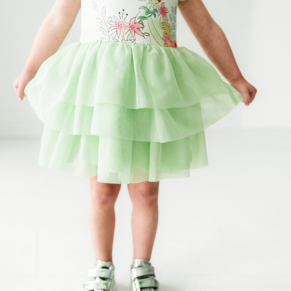 Close up image of a child wearing a Tiana flutter tiered tutu dress with bloomer