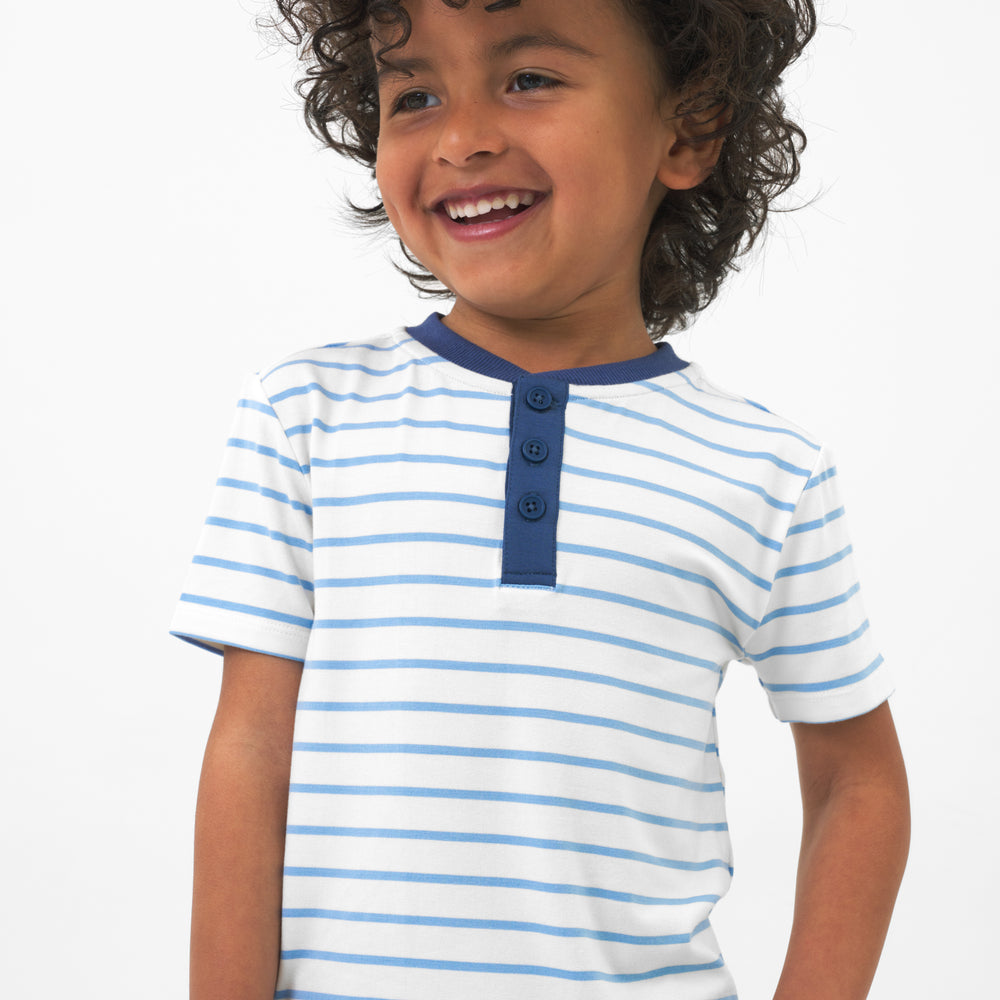 Close up image of a child wearing Blue Waves Stripes Henley Tee