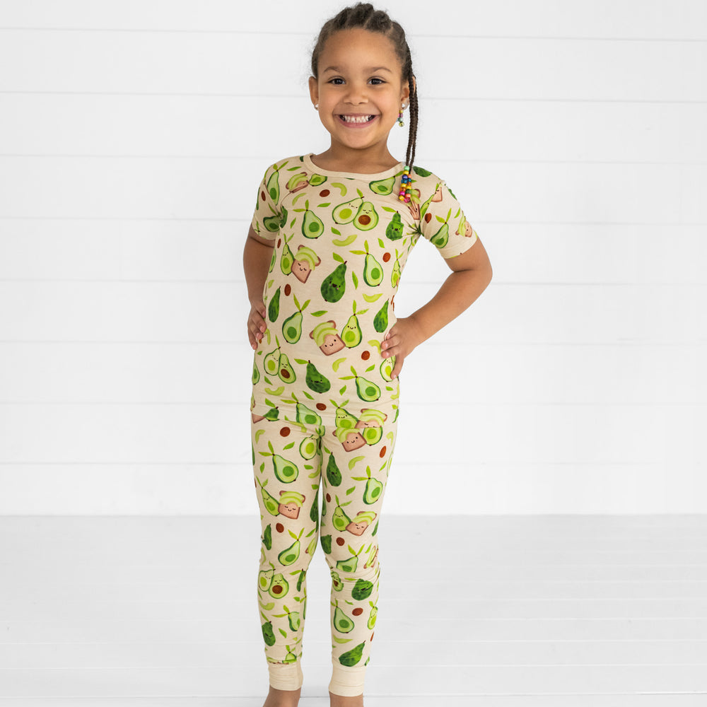 Image of a child posing wearing an Avocado Toast two piece short sleeve pj set