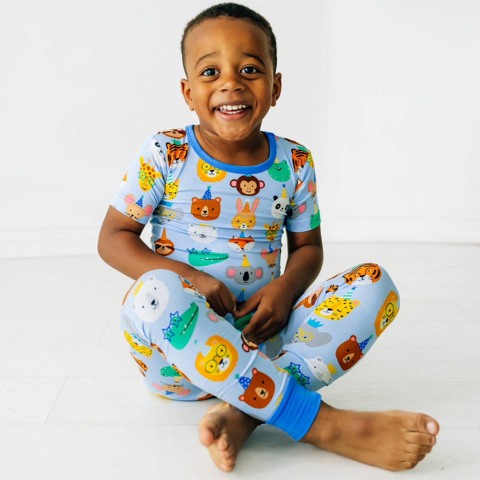 Boy sitting wearing Blue Party Pals Two-Piece Pajama Set