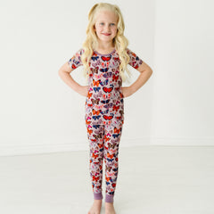 Child wearing a Butterfly Kisses two-piece short sleeve pajama set