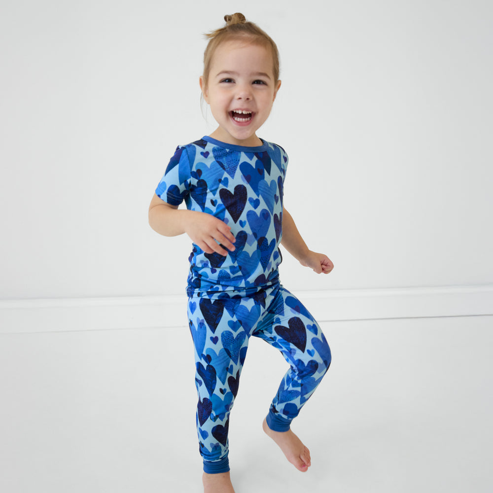 Girl standing wearing Blue Hearts & Crafts short sleeve and pants pajama set.