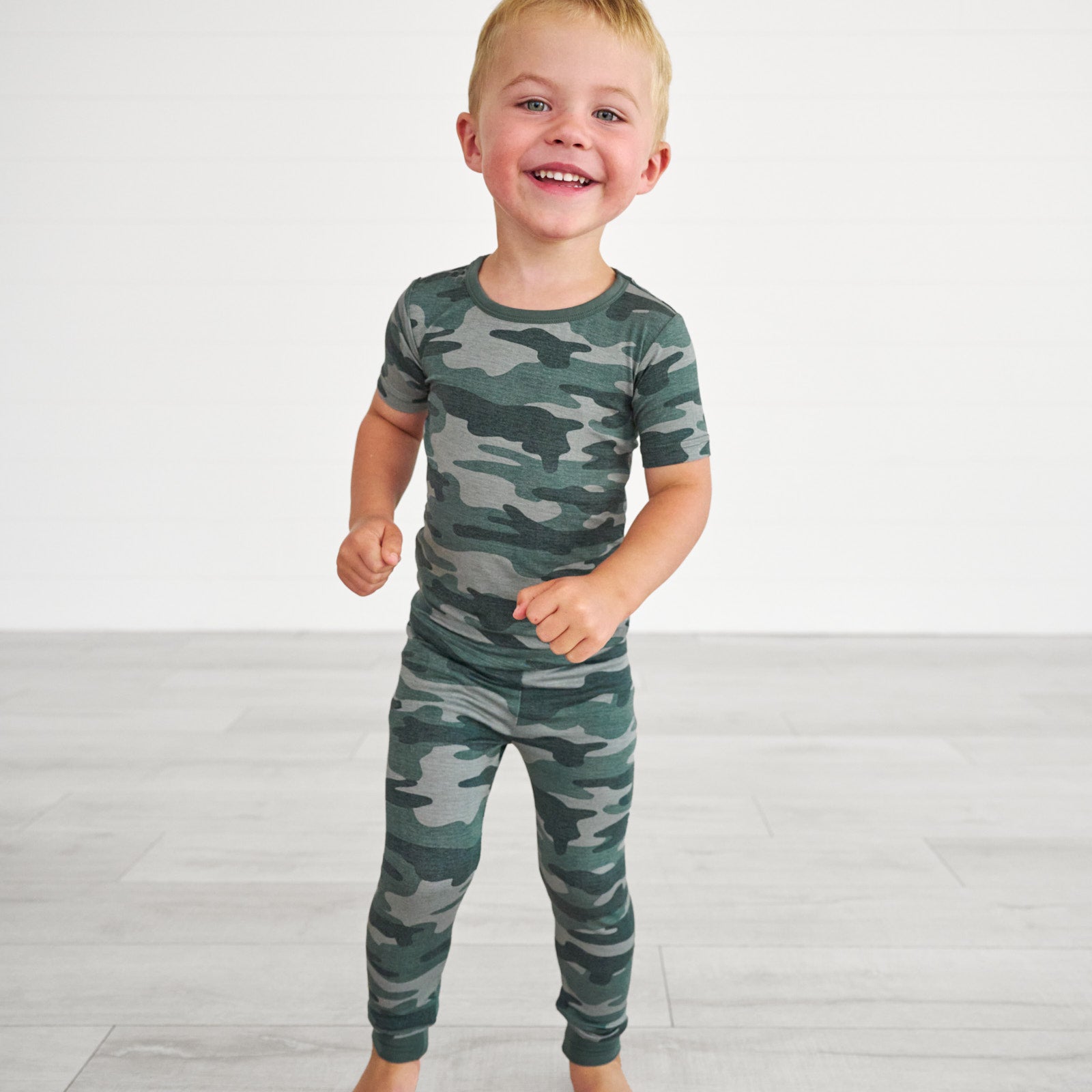 Boy wearing the Vintage Camo Two-Piece Short Sleeve Pajama Set