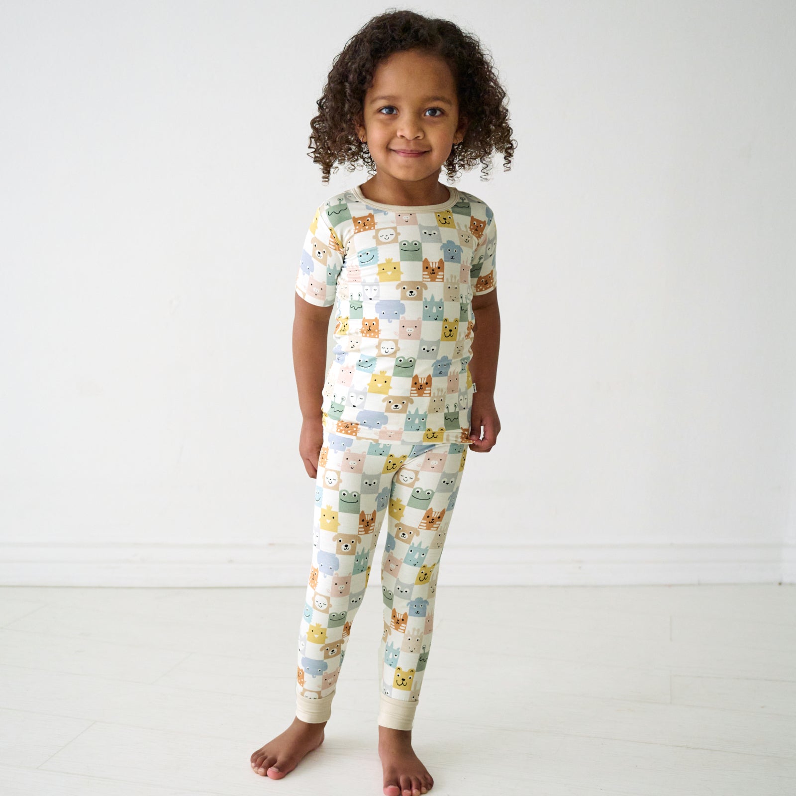 Child wearing a Check Mates two-piece short sleeve pajama set