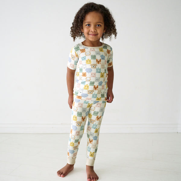 Child wearing a Check Mates two-piece short sleeve pajama set