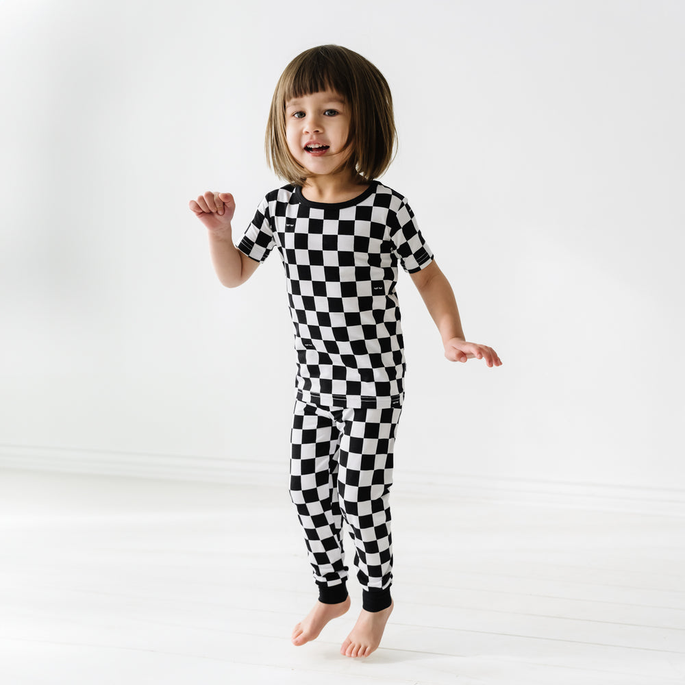 child jumping wearing a Cool Checks two piece short sleeve pj set