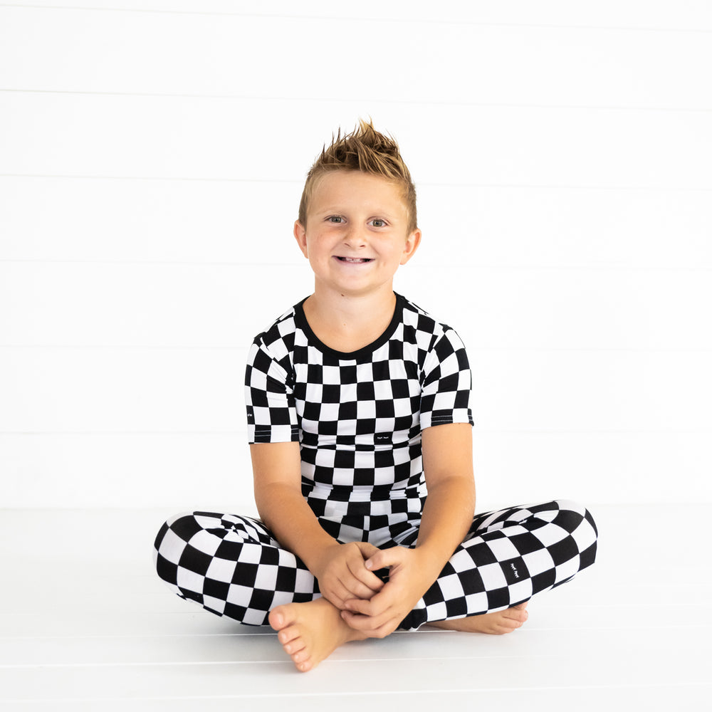 child sitting wearing Cool Checks two piece short sleeve pj set