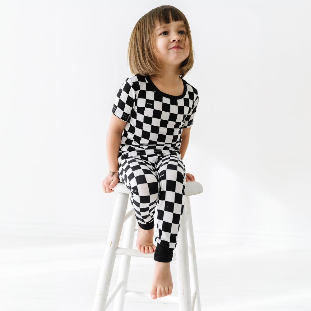 child sitting on a stool wearing Cool Checks short sleeve pj set