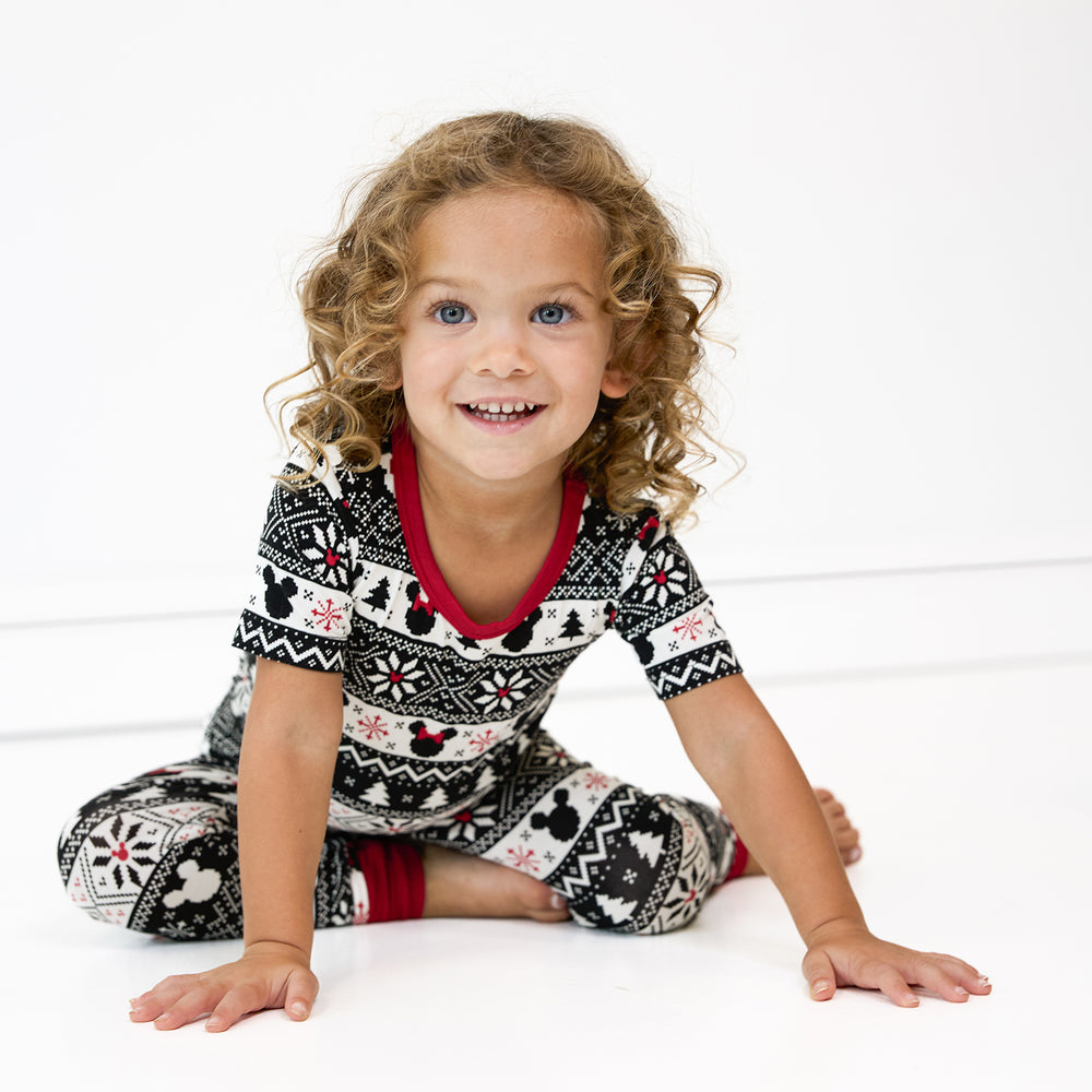 Child sitting wearing two piece Mickey Fair Isle short sleeve pj set