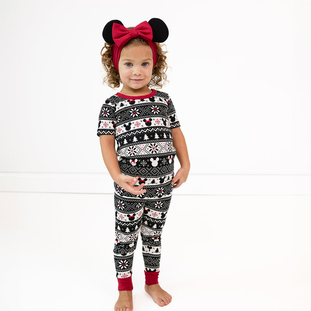 Child wearing two piece Mickey Fair Isle short sleeve pj set paired with minnie ears