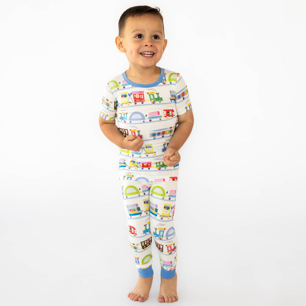 Child wearing the Education Express Two-Piece Short Sleeve Pajama Set