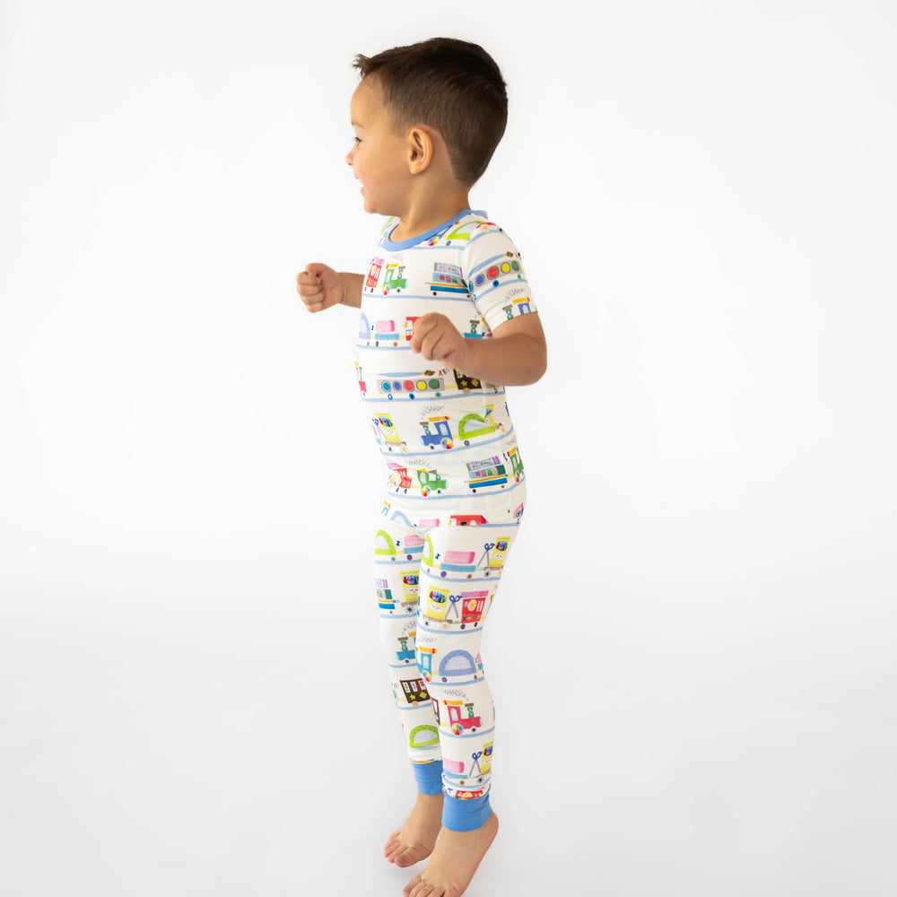 Side view image of child wearing the Education Express Two-Piece Short Sleeve Pajama Set