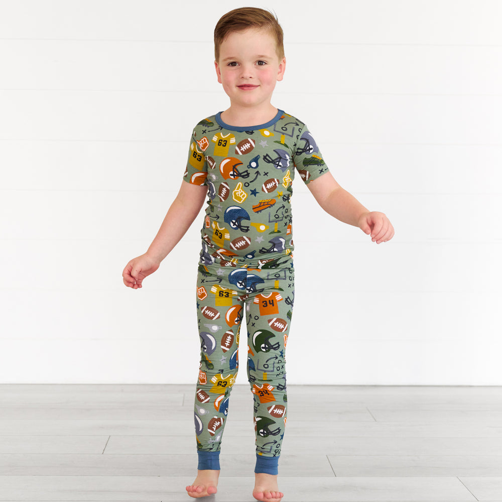 Boy wearing the touchdown-time-two-piece-short-sleeve-pajama-set