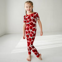 Child wearing a Love Bug printed two-piece short sleeve pajama set