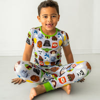 Alternate image of a child sitting on the ground wearing a Legends of the Galaxy two-piece short sleeve pajama set