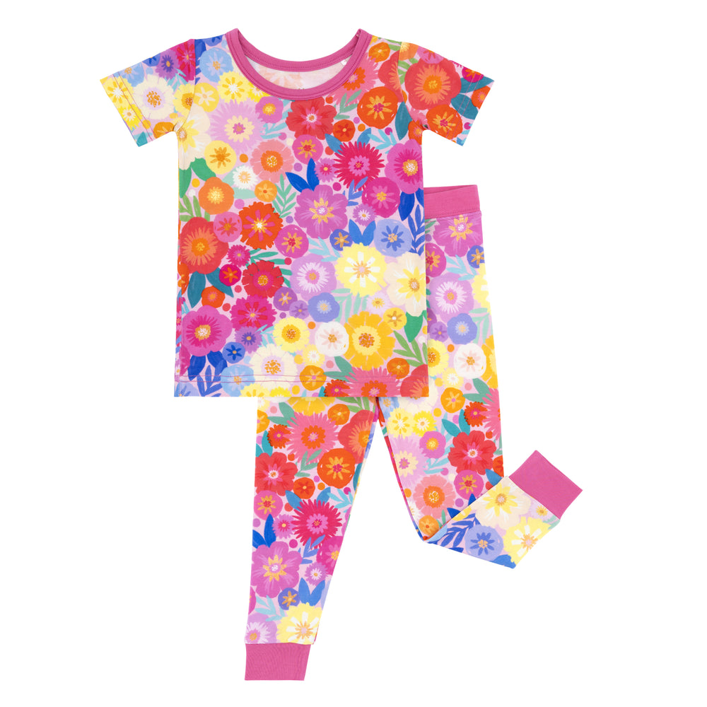 Flat lay image of a Rainbow Blooms two-piece short sleeve pajama set