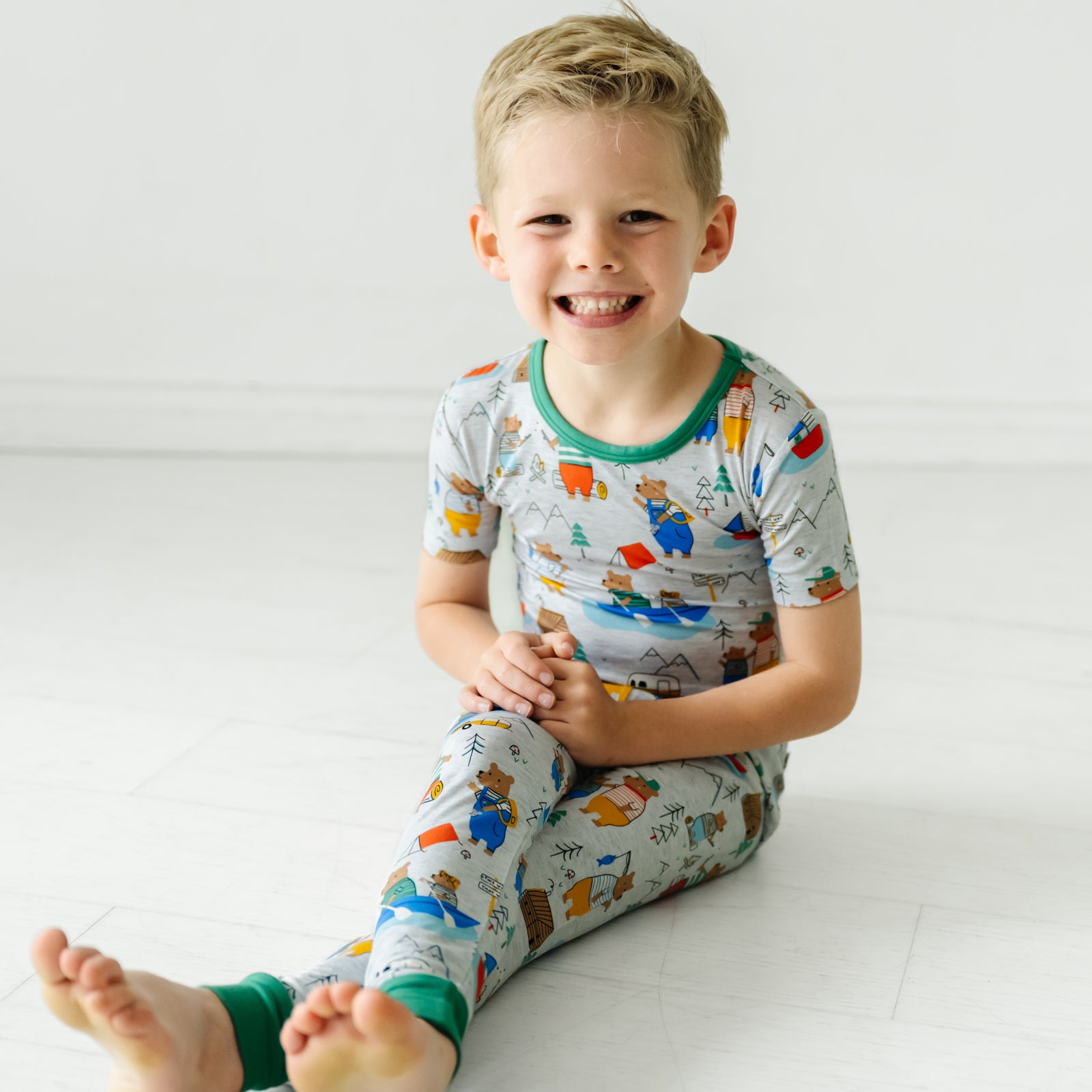Alternate image of a child sitting wearing a Papa Bear two piece short sleeve pajama set