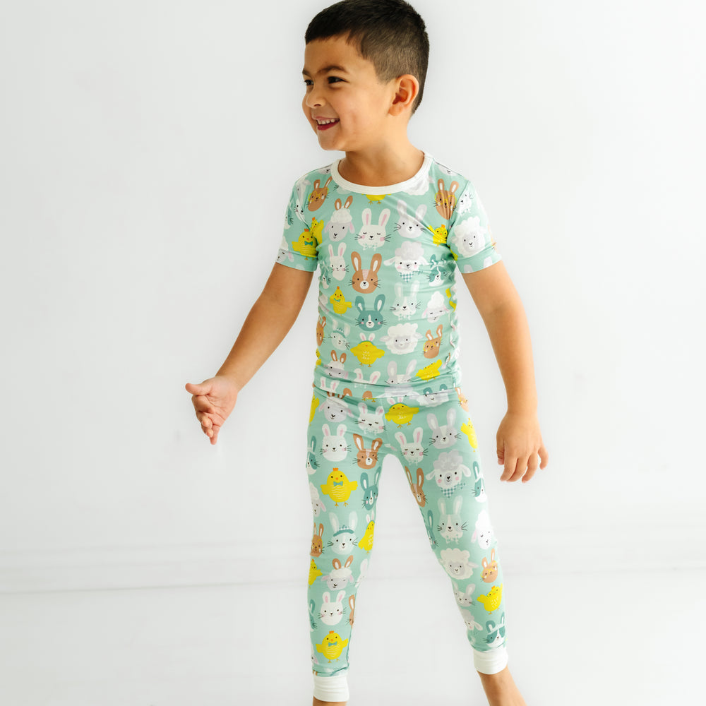 Click to see full screen - Profile view of a child wearing a Aqua Pastel Parade two piece short sleeve pajama set