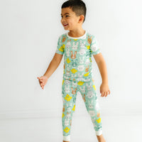 Profile view of a child wearing a Aqua Pastel Parade two piece short sleeve pajama set