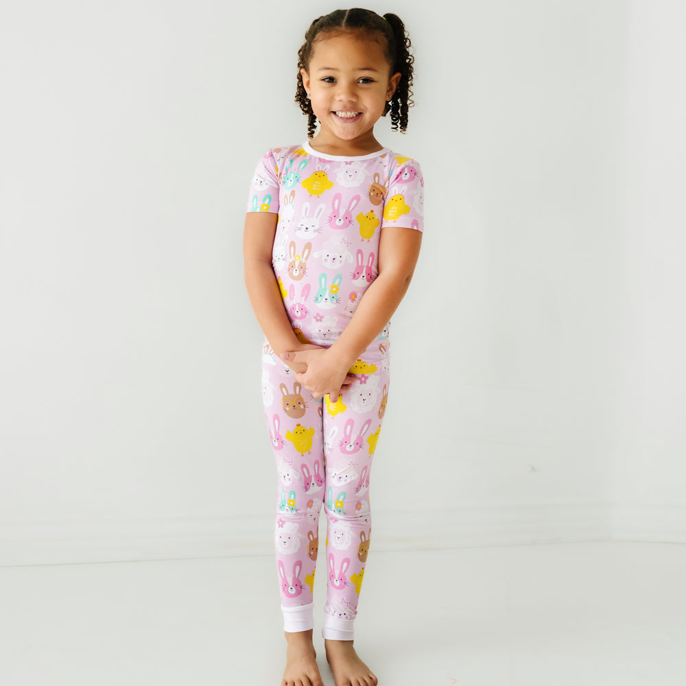 Click to see full screen - Child posing wearing a Pink Pastel Parade two piece short sleeve pajama set