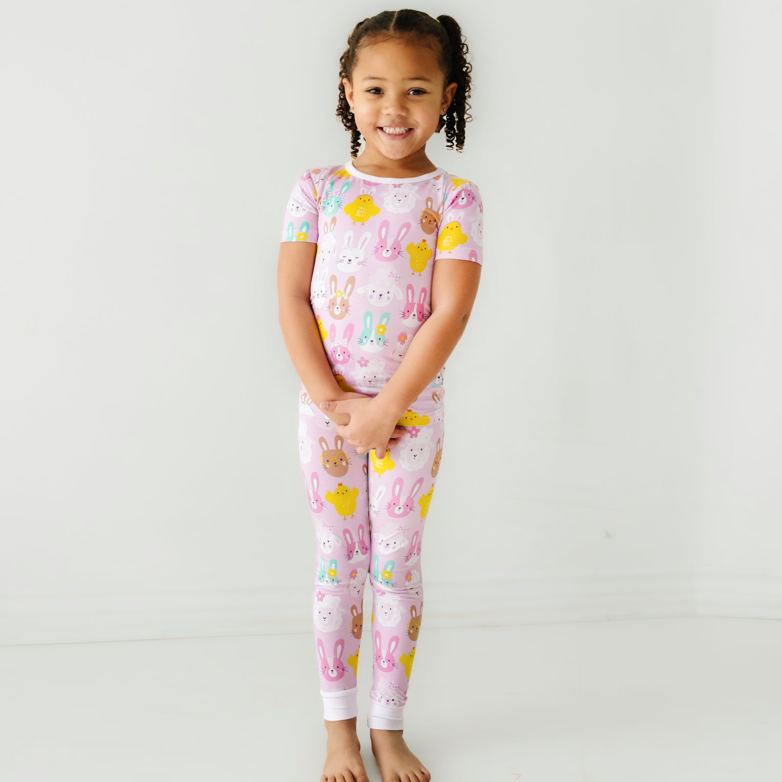 Child posing wearing a Pink Pastel Parade two piece short sleeve pajama set