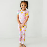 Child posing wearing a Pink Pastel Parade two piece short sleeve pajama set