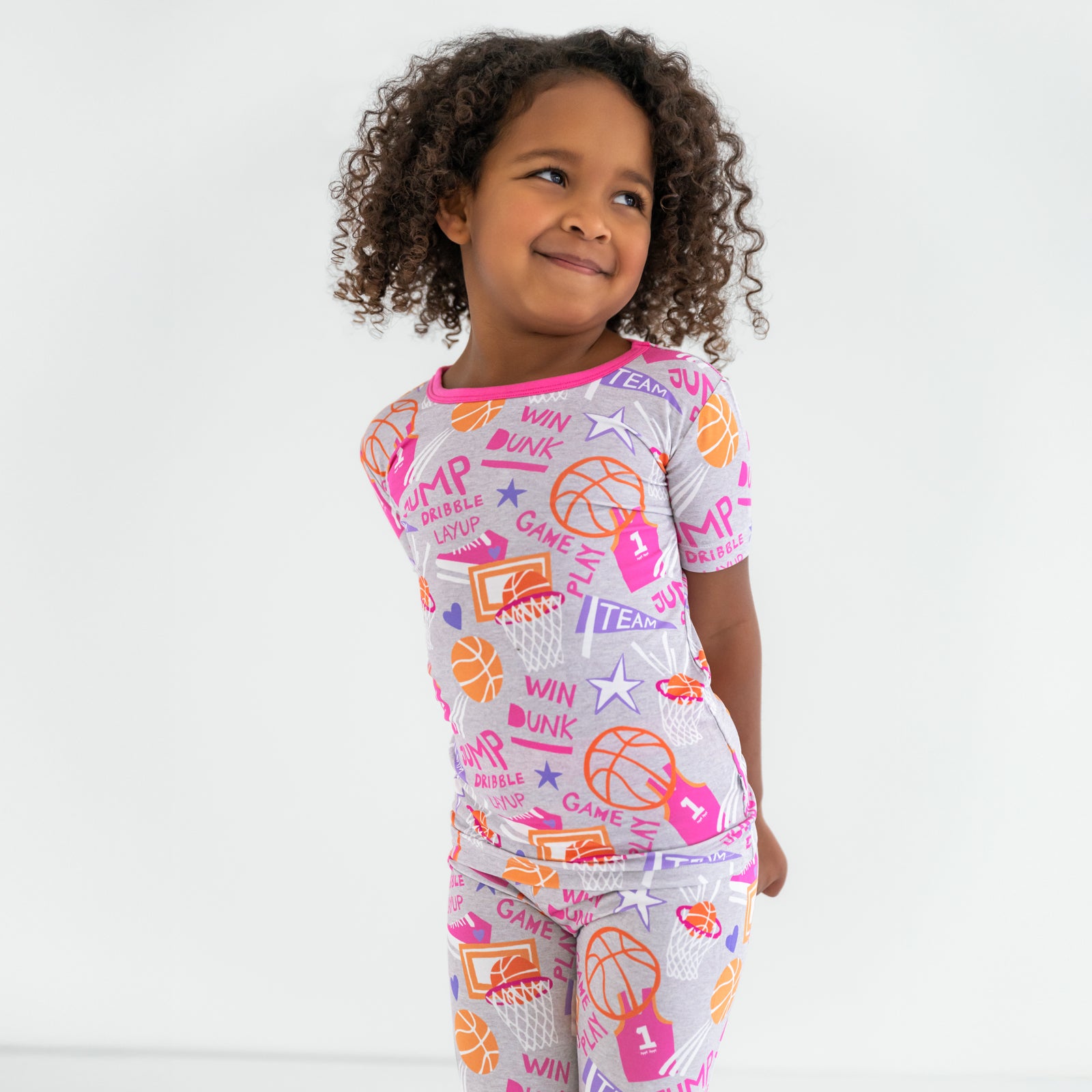 Close up of child wearing the Pink Slam Dunk short sleeve pajama set
