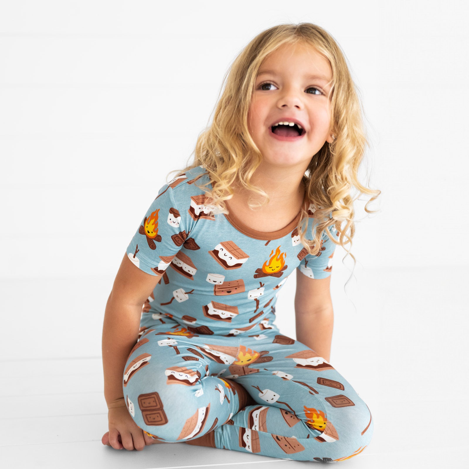 child sitting wearing a S'mores Galore short sleeve two piece pj set