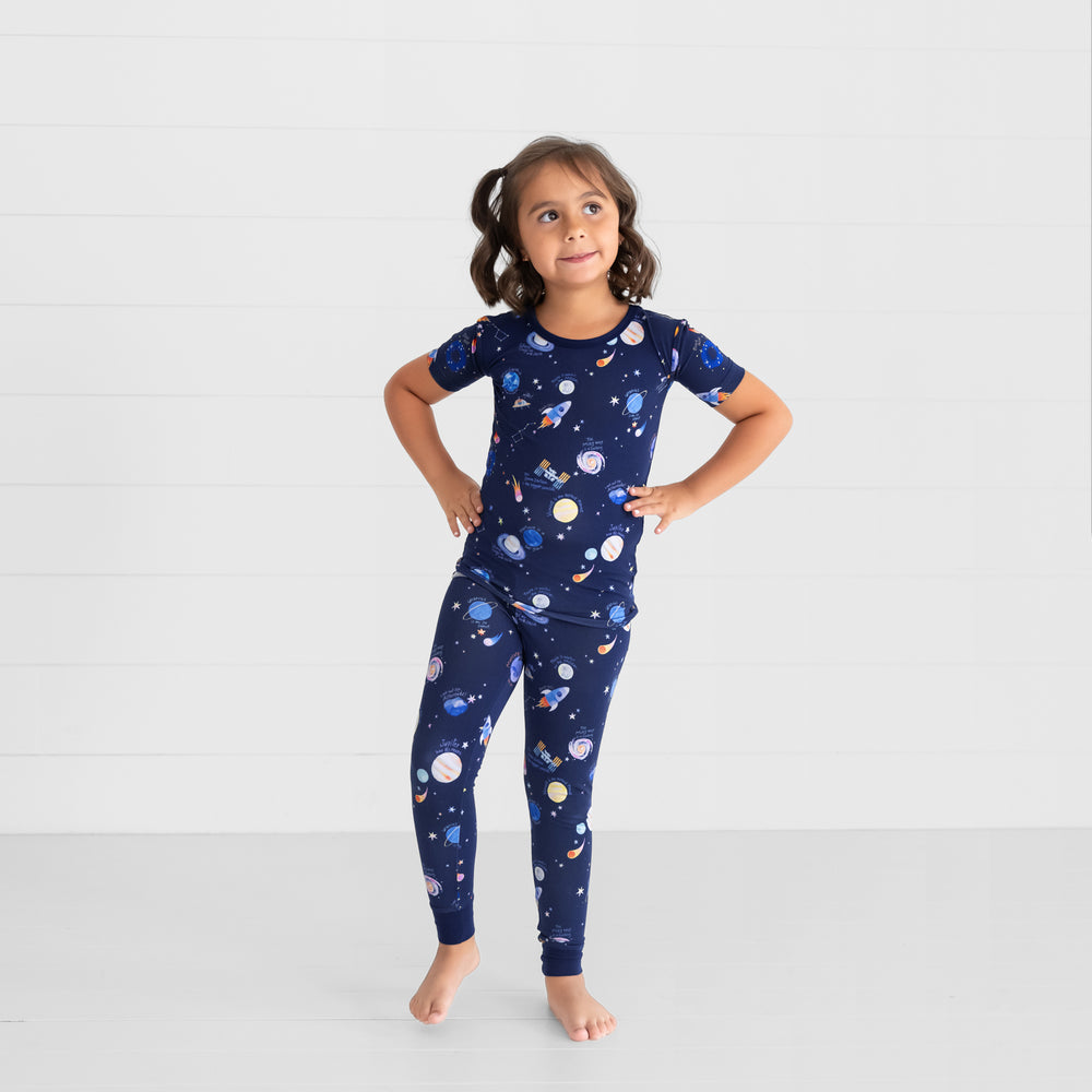 Image of a child posing wearing a Through My Telescope two piece short sleeve pj set