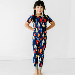 Child posing wearing a Navy Space Explorer two piece short sleeve pajama set