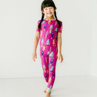 child wearing a Pink Space Explorer two piece short sleeve pajama set