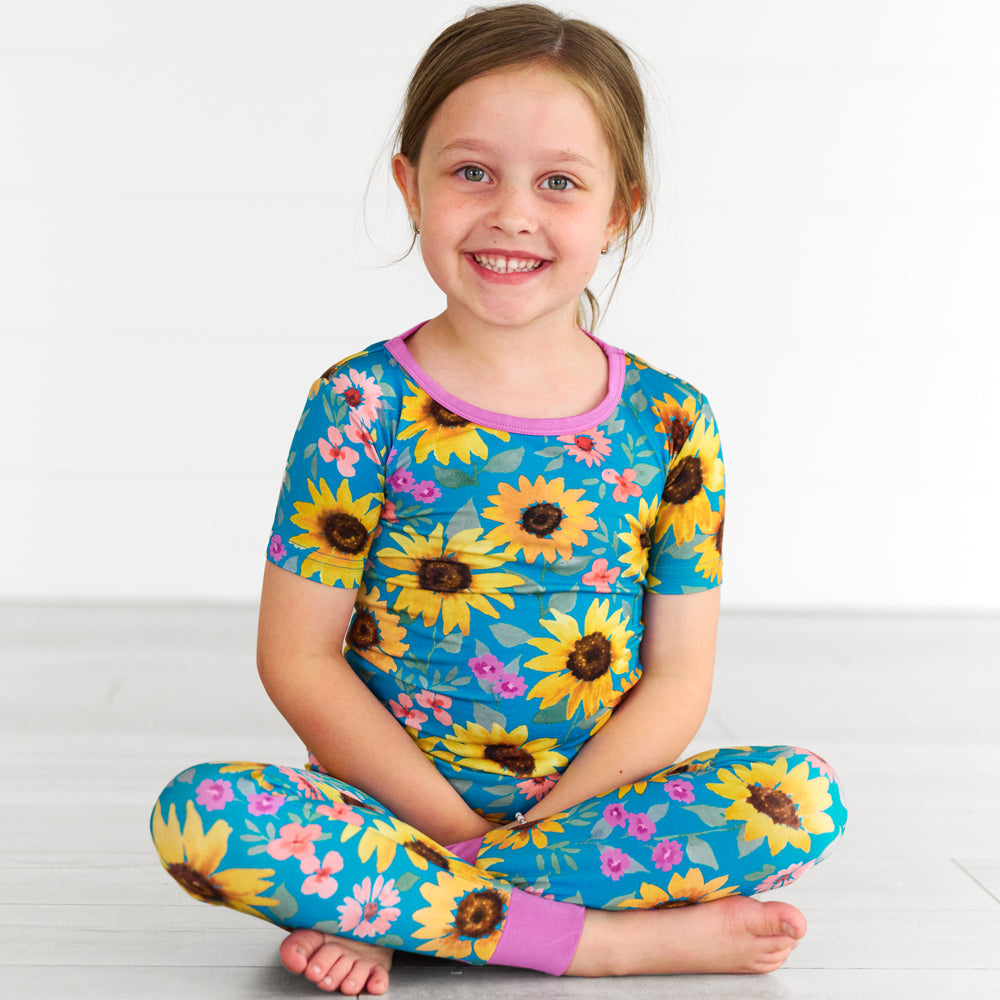 Alternative image of girl sitting while wearing the Sunflower Fields Two-Piece Short Sleeve Pajama Set