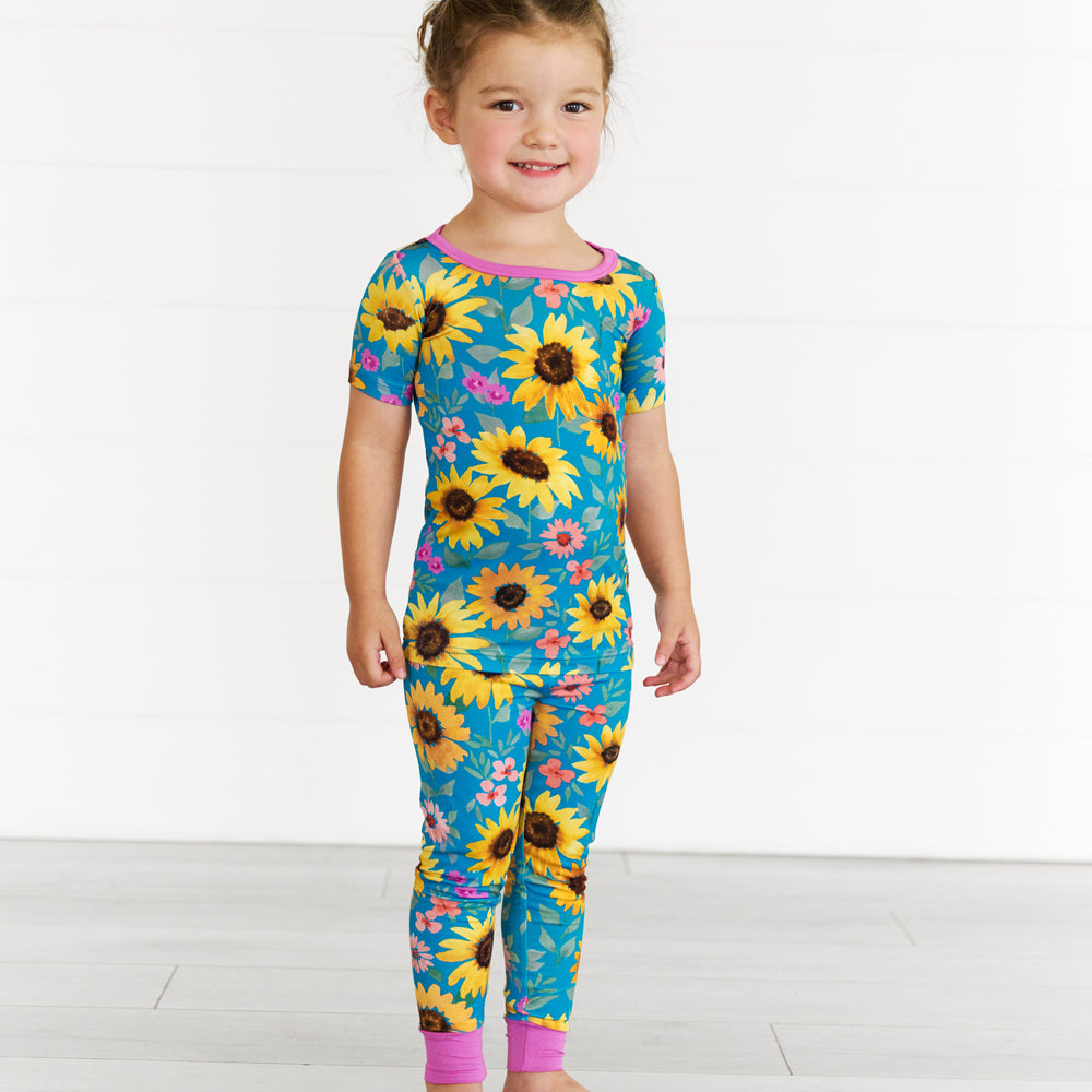 Girl wearing the Sunflower Fields Two-Piece Short Sleeve Pajama Set