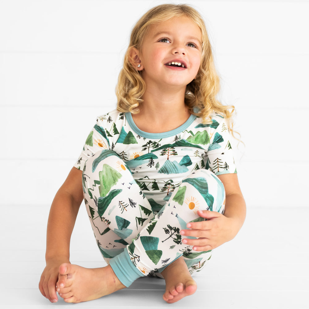 child sitting wearing a Mountain Mist two piece short sleeve pajama set