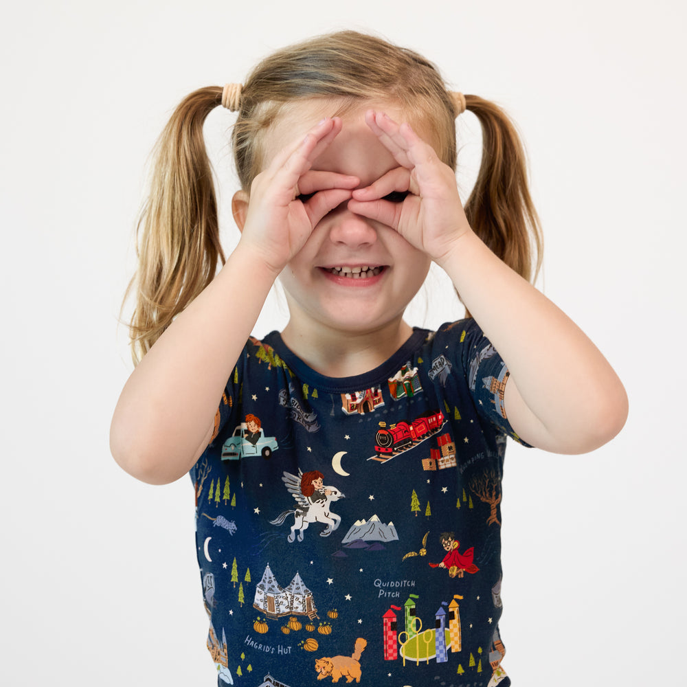 Alternate close up image of a child posing wearing An Evening at Hogwarts two piece short sleeve pj set